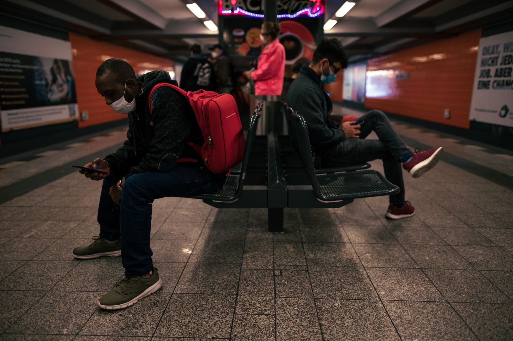 Tube passengers waiting for the tube in the station during covid wearing face masks