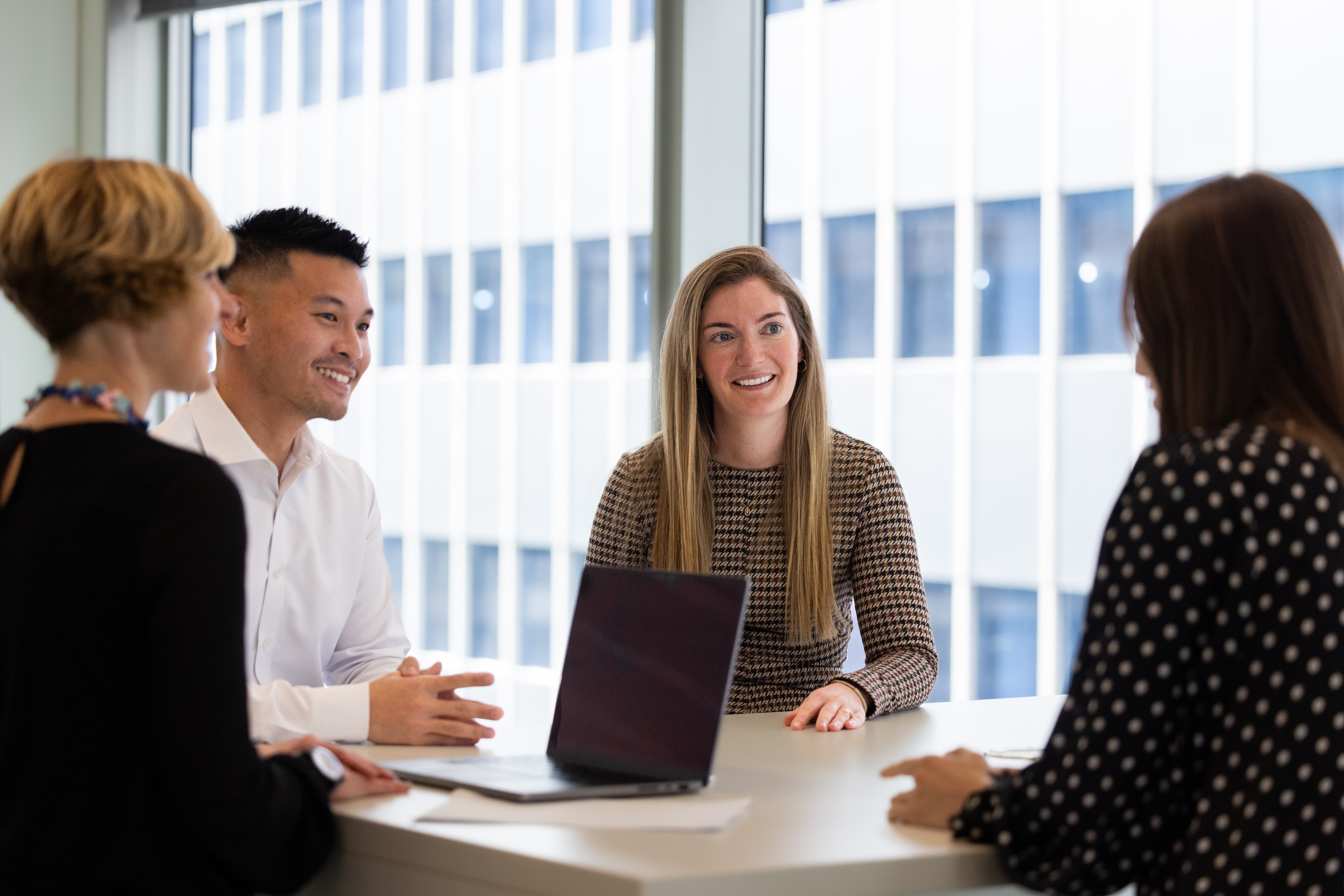 A group of people around a table talking  