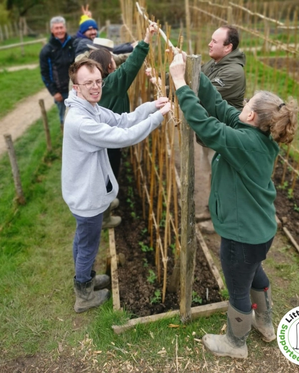Comunity group working on a gardening project Comunity group working on a gardening project