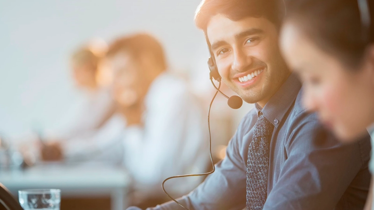 Man smiling with headset in office Man smiling with headset in office